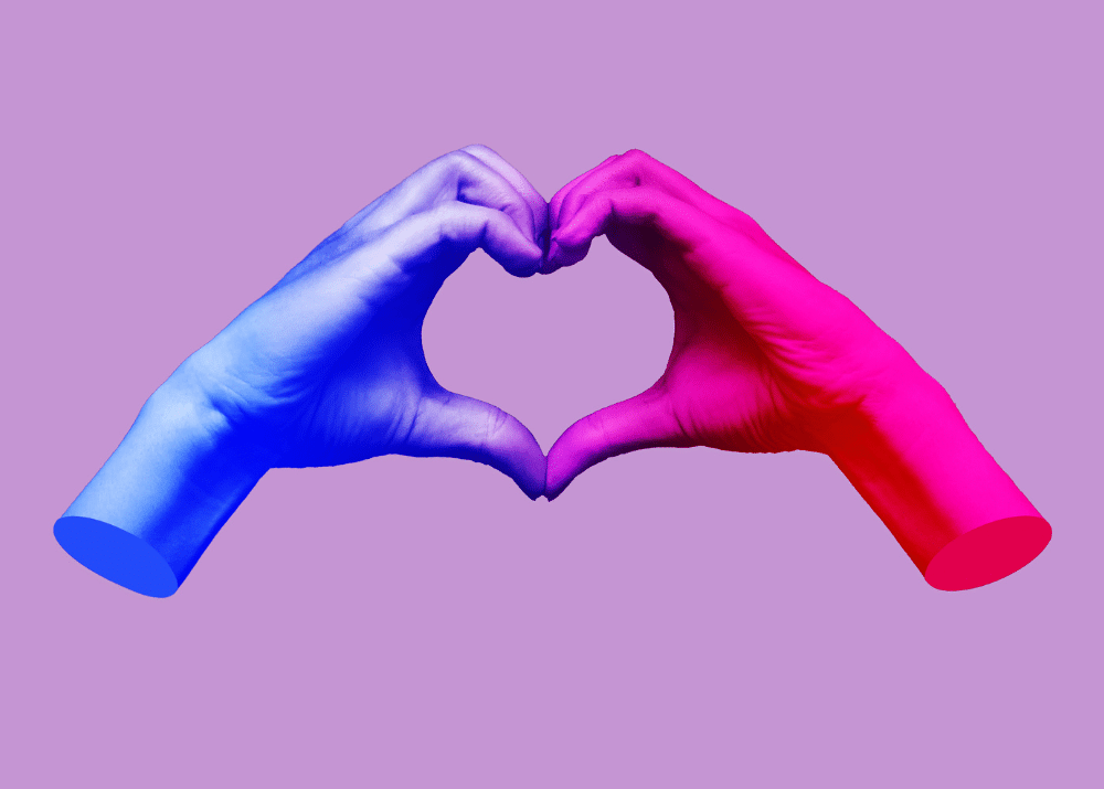 Zwei Hände formen ein Herz, eine in Blau und eine in Pink, vor einem lila Hintergrund.